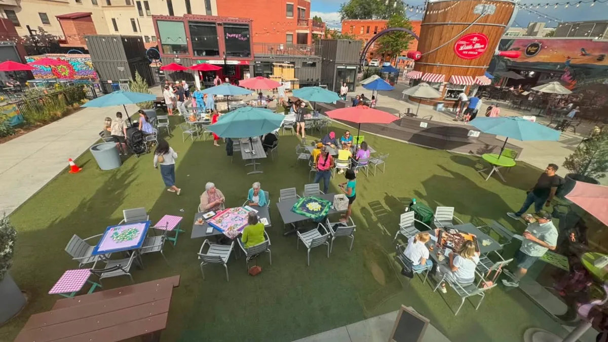 Open Play tables spread across the central plaza at The Exchange in Fort Collins