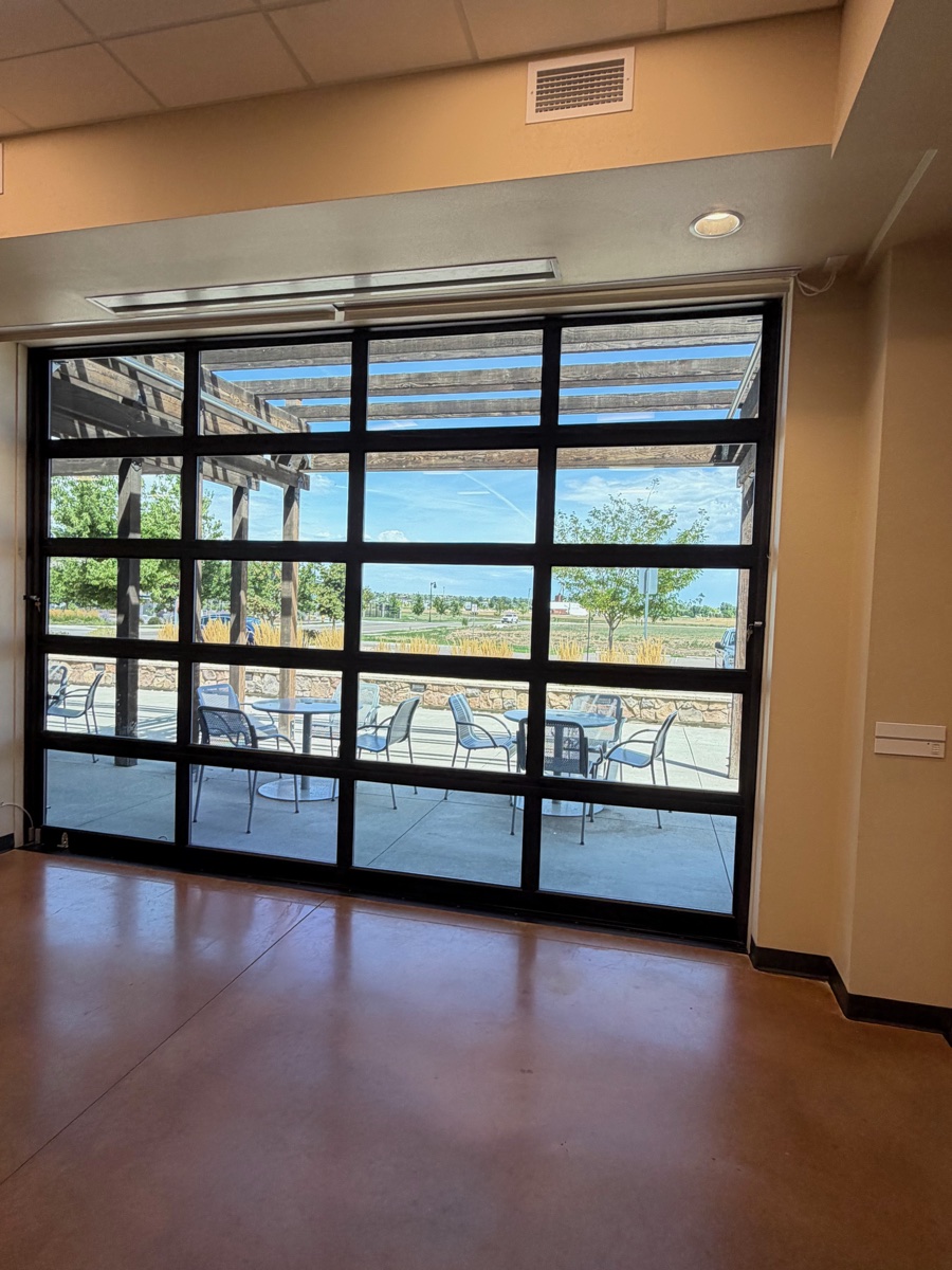 Glass doors from the Timnath Community Room to the covered patio
